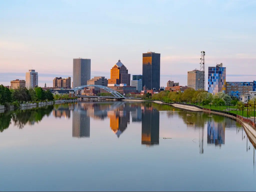 Rochester, New York, USA with the city skyline of Rochester, New York along Genesee River at sunset.