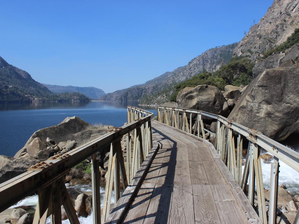 Wapama Falls footbridge along the Hetch Hetchy reservoir in Yosemite National Park, with views over the cascading waterfalls