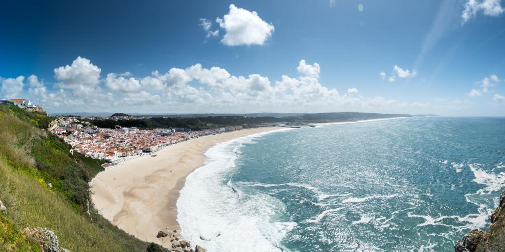 Waves crash onto the shore in Praia da Nazare, Portugal