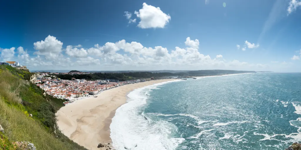 Waves crash onto the shore in Praia da Nazare, Portugal