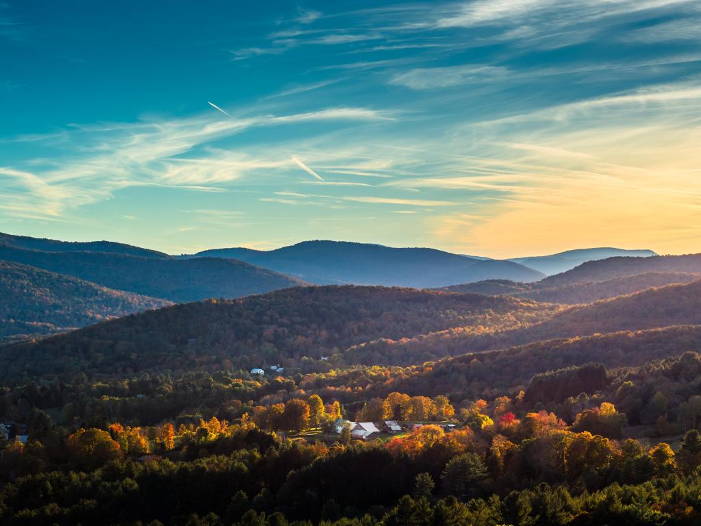 Woodstock, Vermont, USA looking down over the south end of Woodstock during the peak of fall foliage season and just before or after sunset.