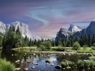 Yosemite National Park, California, USA taken at Yosemite Valley at early evening, with the lake and trees in the foreground and the mountain cliffs in the background.