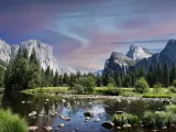 Yosemite National Park, California, USA taken at Yosemite Valley at early evening, with the lake and trees in the foreground and the mountain cliffs in the background.