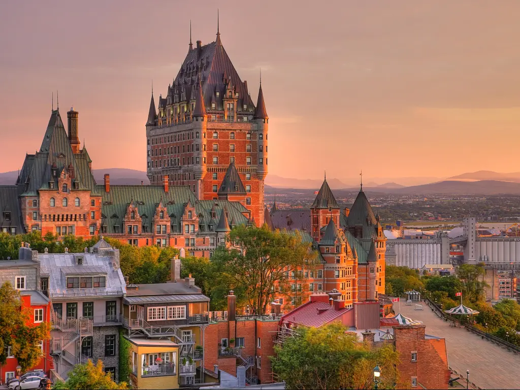 Old Quebec City, Quebec, Canada taken at Frontenac Castle in Old Quebec City in the beautiful sunrise light with hills in the distance and colorful buildings in the foreground. 