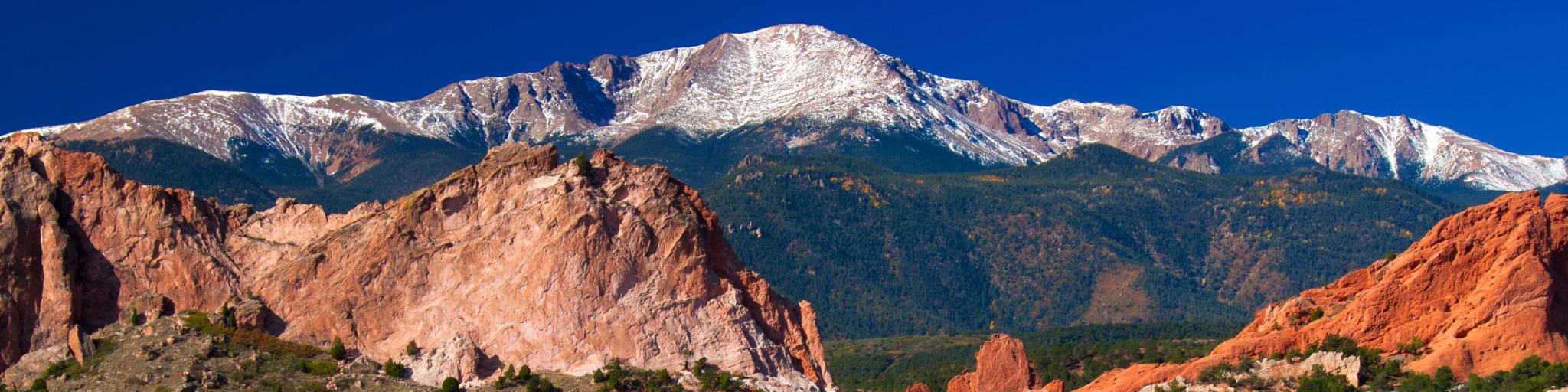 Garden of the Gods, Colorado Springs, USA with a beautiful view of the Garden of the Gods Park with Pikes Peak soaring in the background, taken on a sunny clear day.