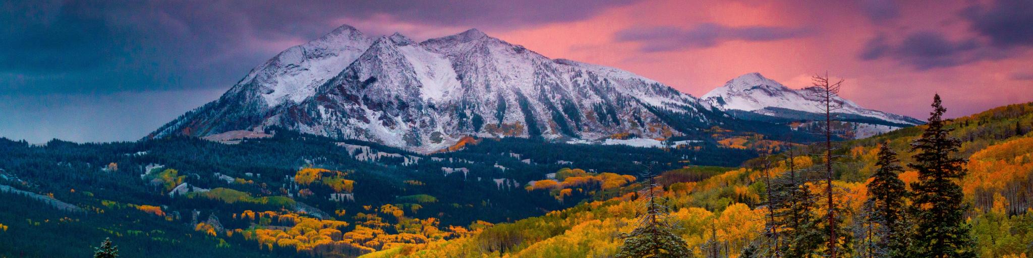Fall rushes in to Colorado in the form of snow and frost at sunrise along Kebler Pass in Crested Butte as East Beckwith Mountain is covered in a fresh dusting.