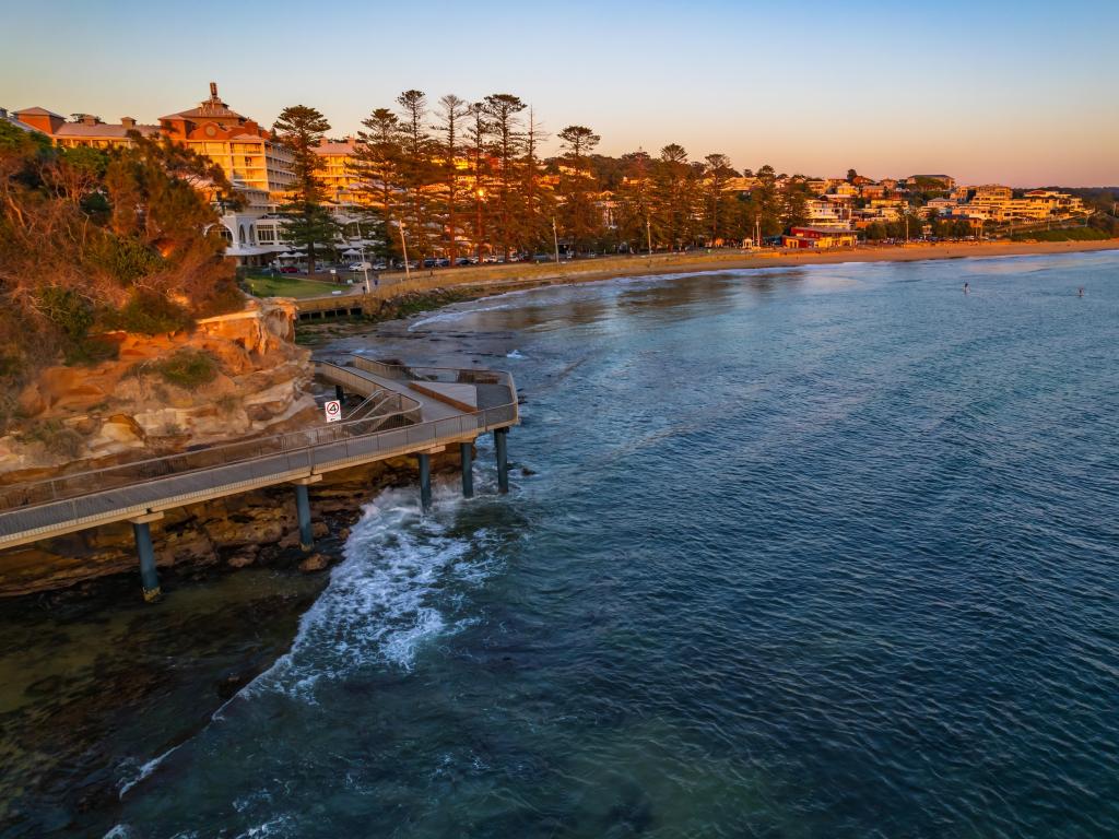 Terrigal, Australia at sunrise showing a seascape overlooking the coastal town in the background. 