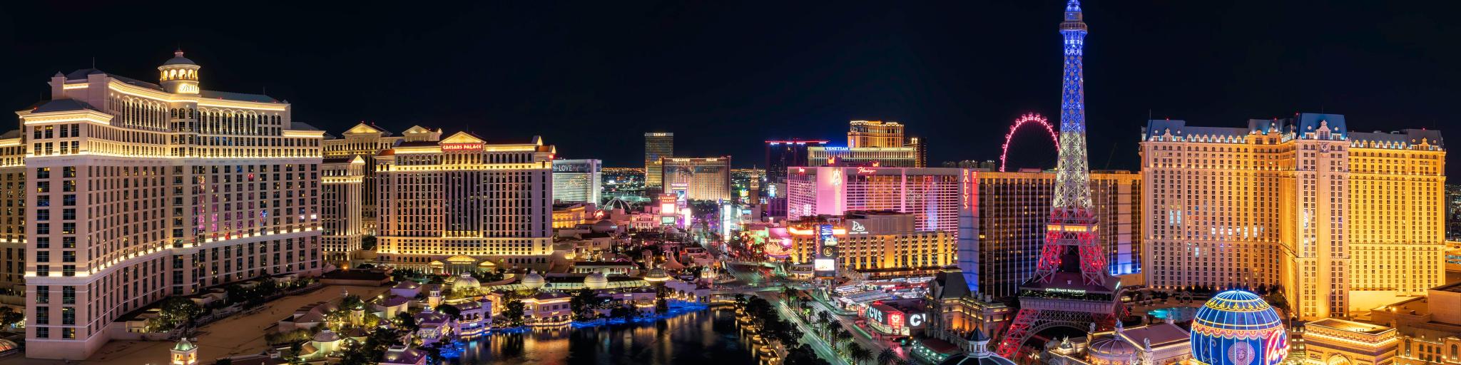 Las Vegas, Nevada, USA with a panorama wide angle view of the Las Vegas Strip and city skyline at night.