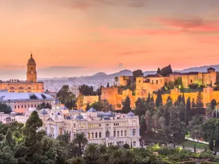 Malaga, Spain old town skyline at dusk.