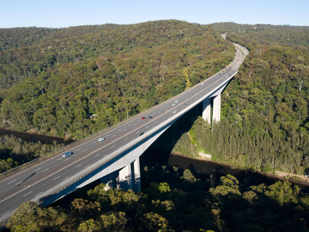 Aerial view of the Mooney Mooney Bridge approaching Sydney, sweeping through the trees