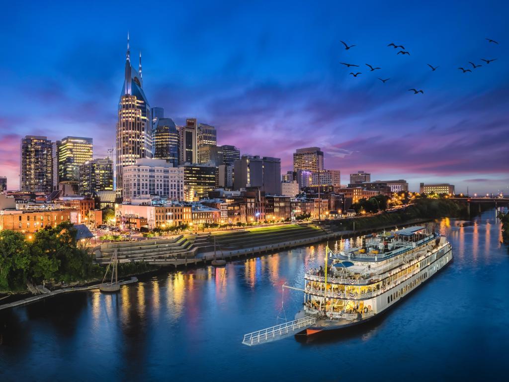 Nashville, Tennessee, USA with the city skyline with river at sunset.