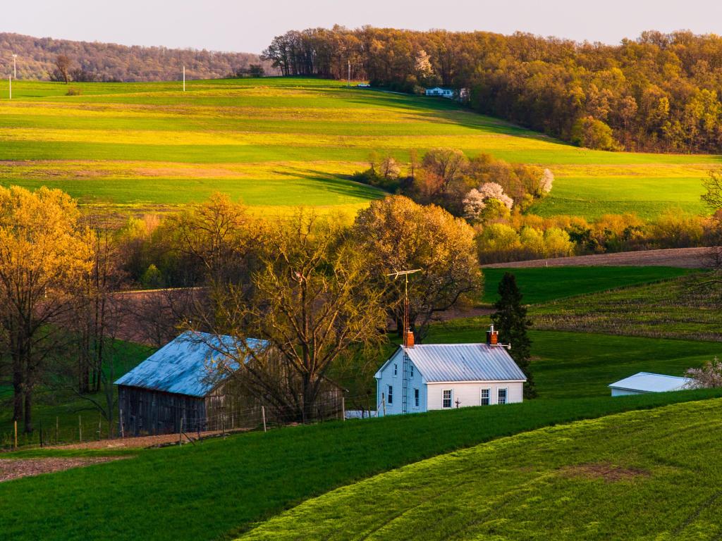 Home and barn on the farm fields and rolling hills of Pennsylvania.