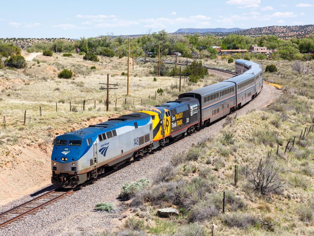 Amtrak Southwest Chief passenger train driving on the railway in desert plains