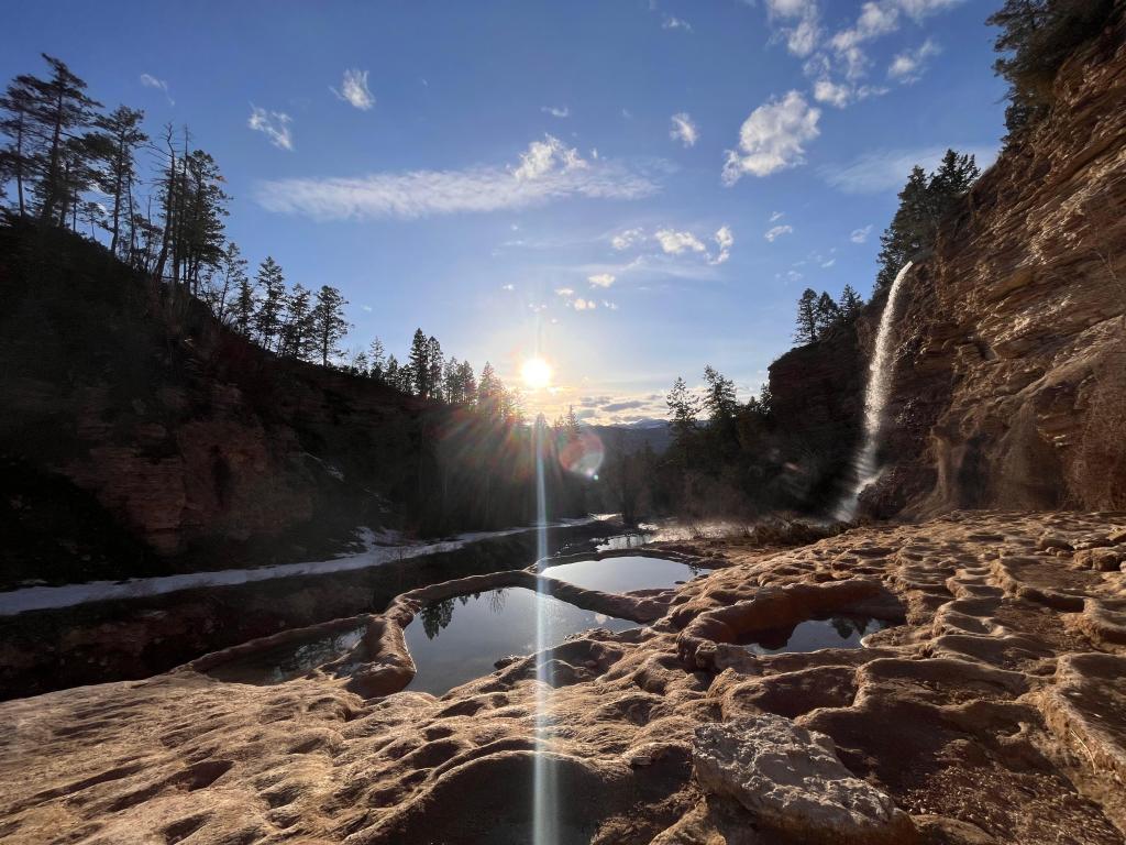 Warm water pools and a warm waterfall among rock formations