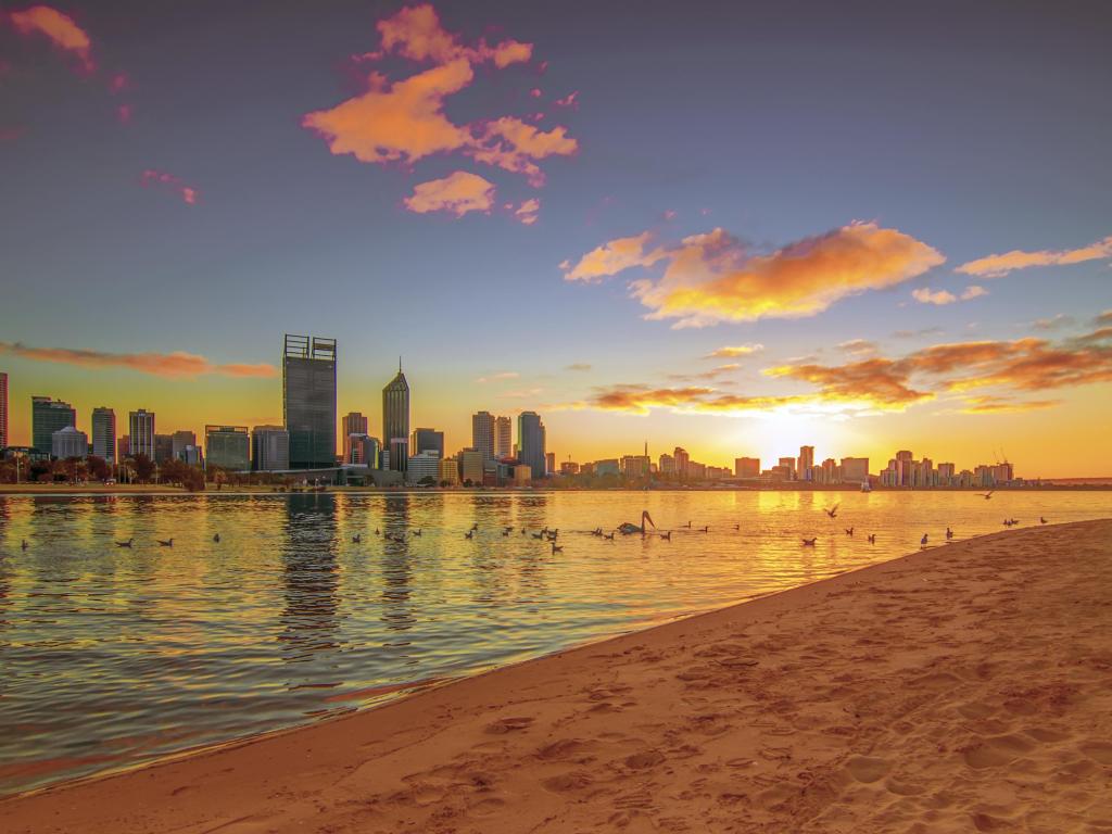 Perth city landscape with the sea and beach opposite demonstrating both sides to Perth, at sunset