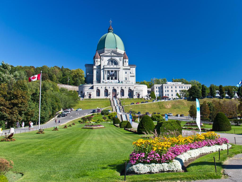 Montreal, Canada taken with the Saint Joseph Oratory, which is a National Historic Site of Canada, and formal garden in the foreground on a sunny day.