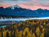 Anchorage, Alaska, USA with a dramatic autumn sunrise in the Chugach mountain range surrounded by colorful autumn foliage in Alaska.