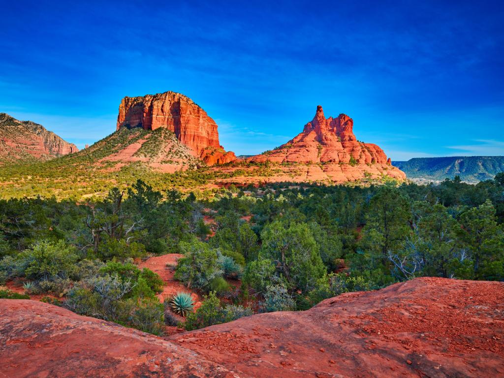 Courthouse Butte and Bell Rock in Coconino National Forest on a sunny day.