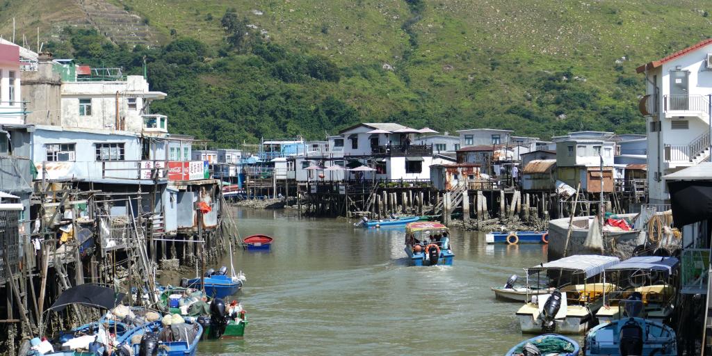 Houses on stilts and boats in the water in the fishing village of Tai O, Hong Kong. 