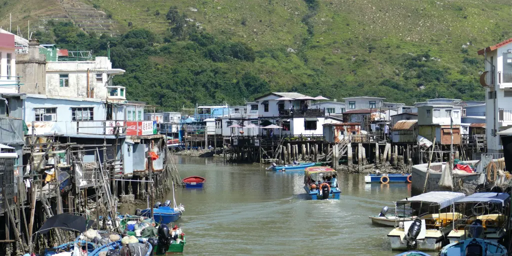 Houses on stilts and boats in the water in the fishing village of Tai O, Hong Kong. 