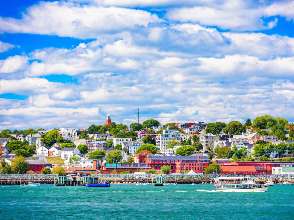 Portland, Maine, USA coastal townscape taken on a sunny day with the sea in the foreground.