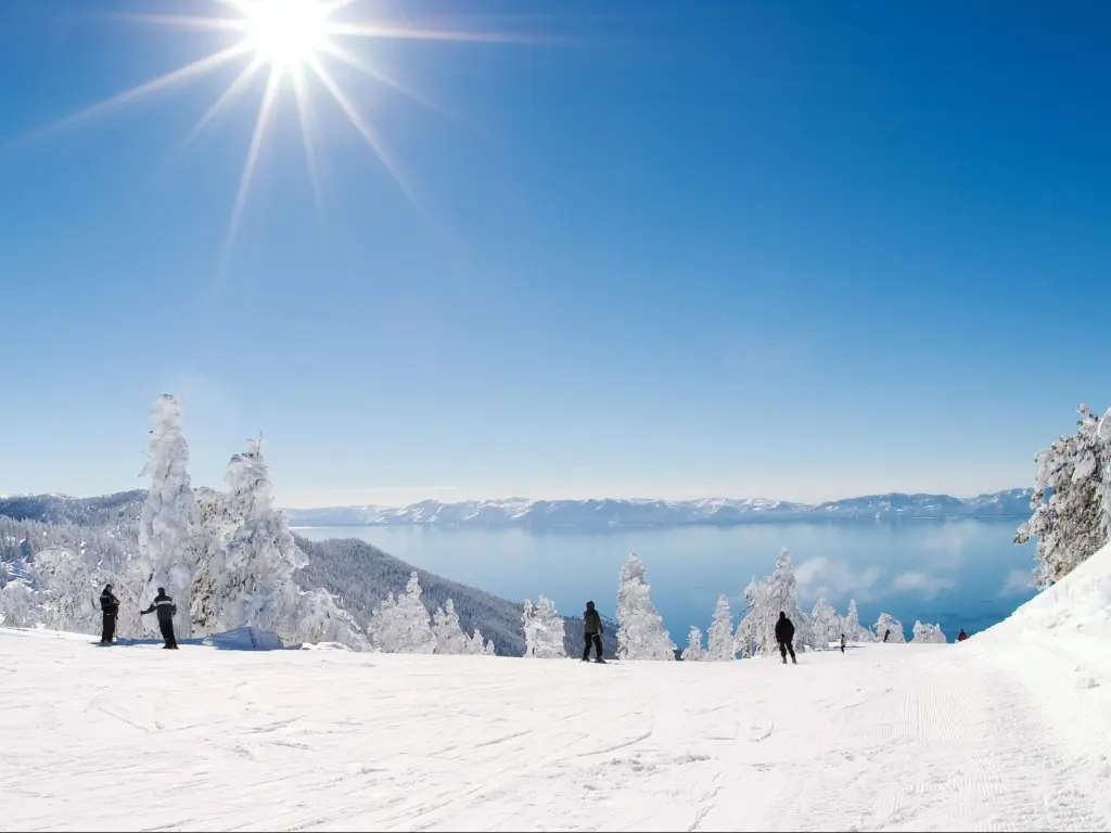 Skiers at the snow-covered slopes of Diamond Peak in Lake Tahoe on a clear day