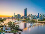 Brisbane, Australia at twilight with the city skyline in the background and the Brisbane river in the foreground. 