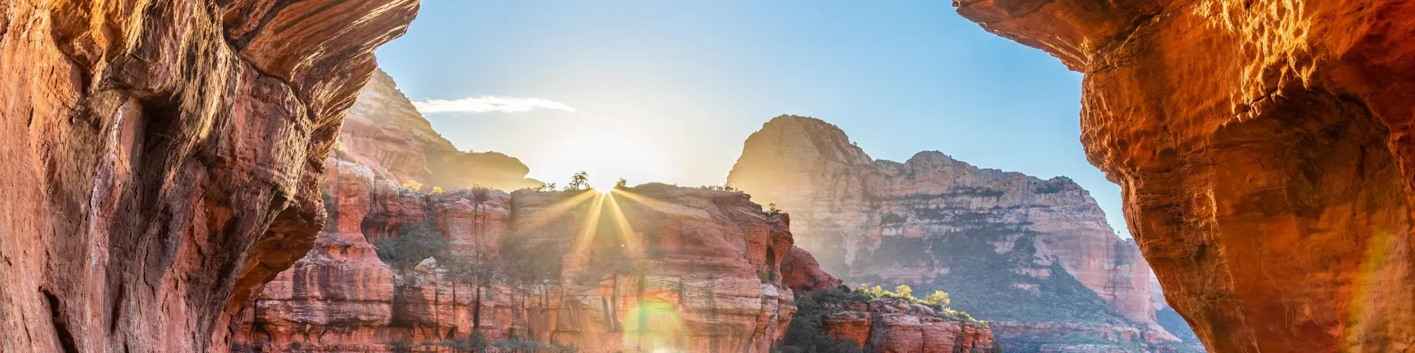 Sunrise view from a window created by two rock formations in Boynton Canyon on a sunny day