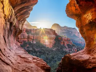 Sunrise view from a window created by two rock formations in Boynton Canyon on a sunny day