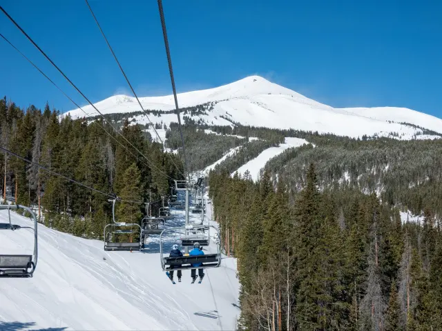 Scenic views around Breckenridge Colorado ski resort town with skiers travelling on ski lift