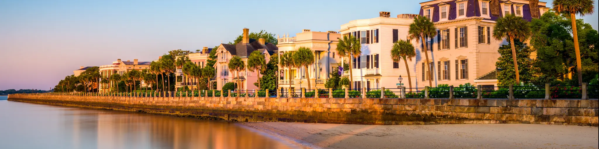 The historic homes near the sea, the Battery in Charleston with beautiful landscape and trees in a clear blue sky morning, South Carolina