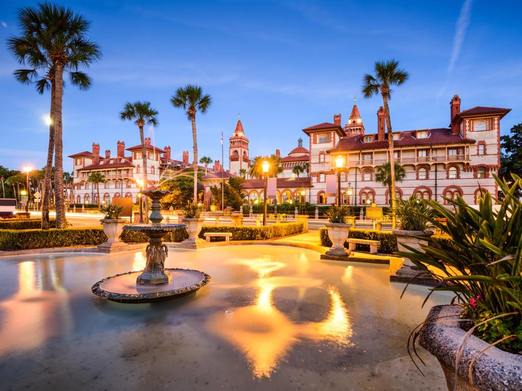 Early twilight at Flagler College in downtown St Augustine, FL, with the grand building and park lit up