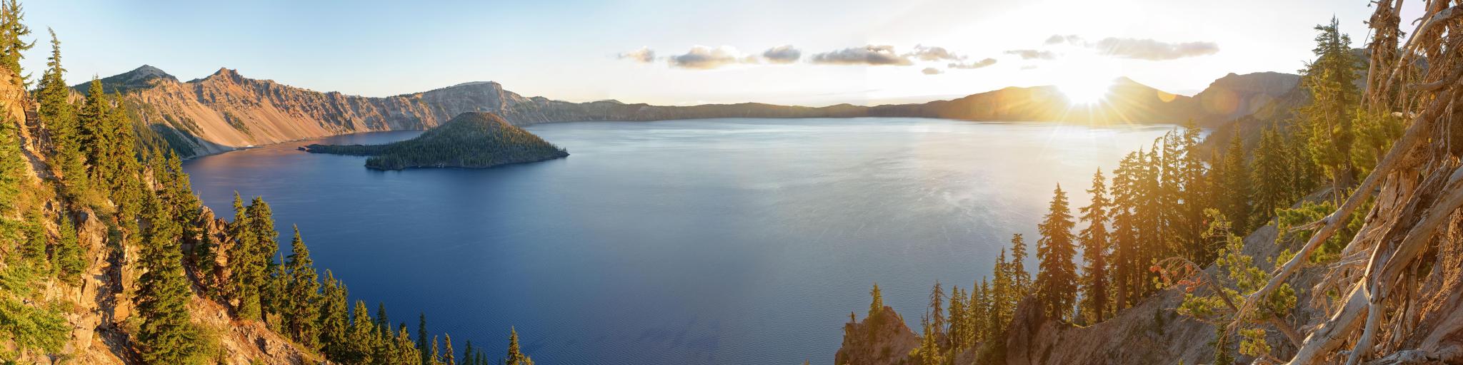 Crater Lake National Park at sunrise in the summer with still calm waters