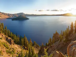 Crater Lake National Park at sunrise in the summer with still calm waters