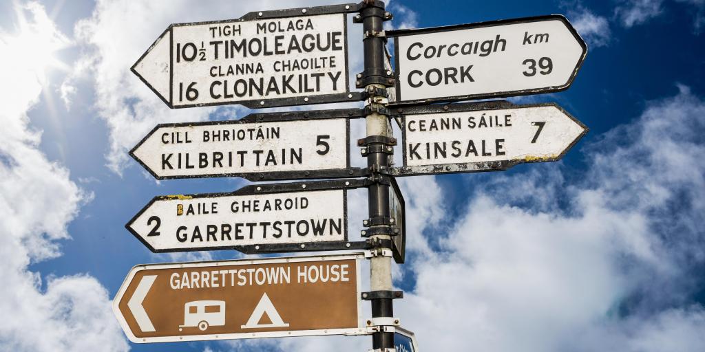 Irish road signs against a blue sky 