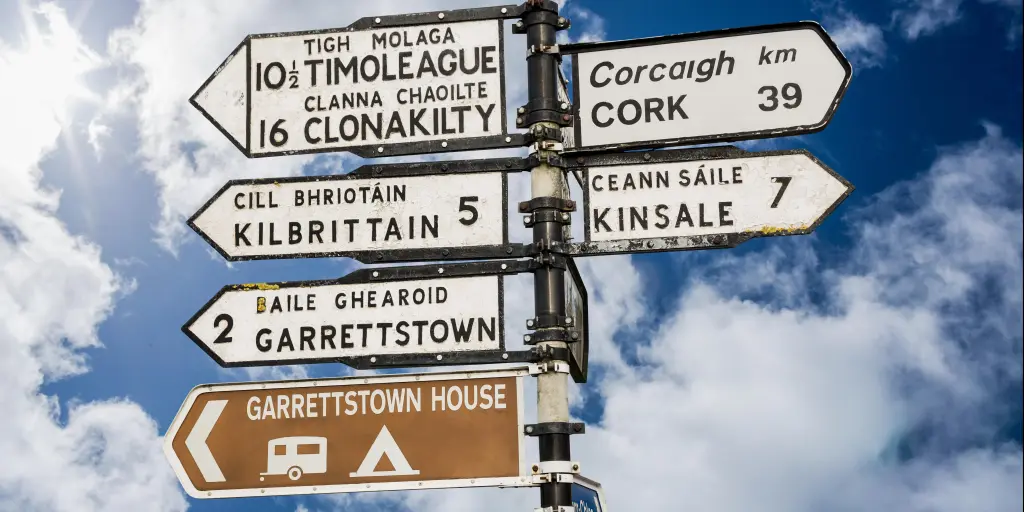 Irish road signs against a blue sky 