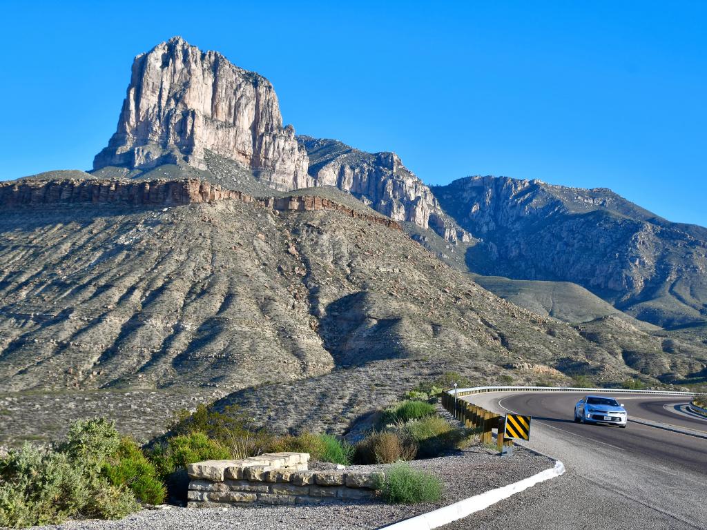 El Paso, Texas : USA Circa September 2019 El Capitan, the 10th-highest peak in Texas. Car coming out of a curve on a mountain road.