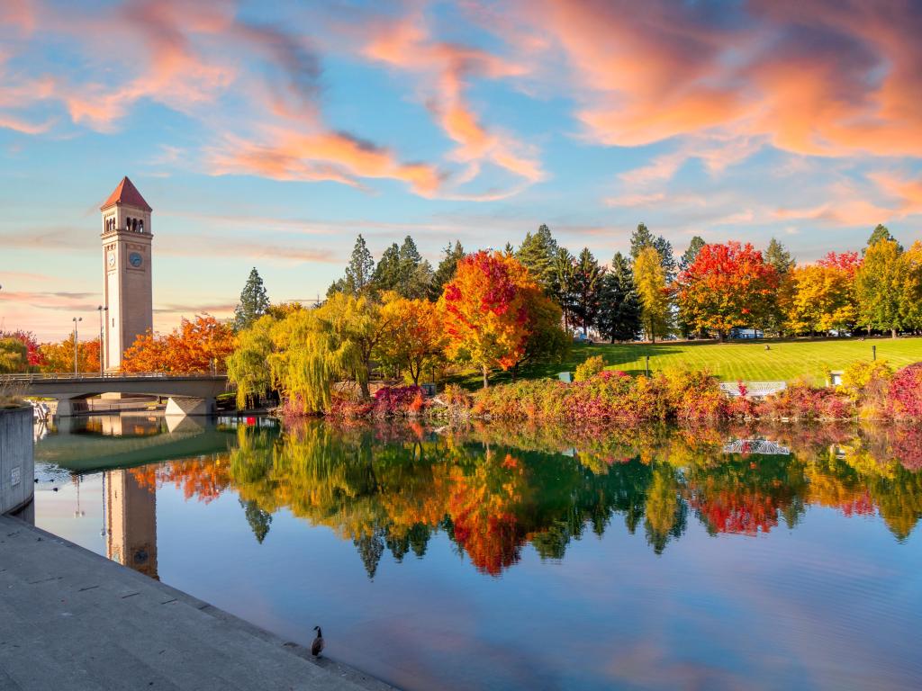 Beautiful autumn foliage of orange, yellow and red, reflected in a lake in one of the waterfront parks in Spokane, Washington