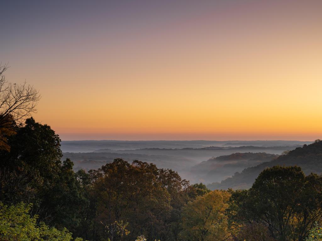 Brown County State Park in Indiana, USA at early morning with mist in an October morning as the sun rises.