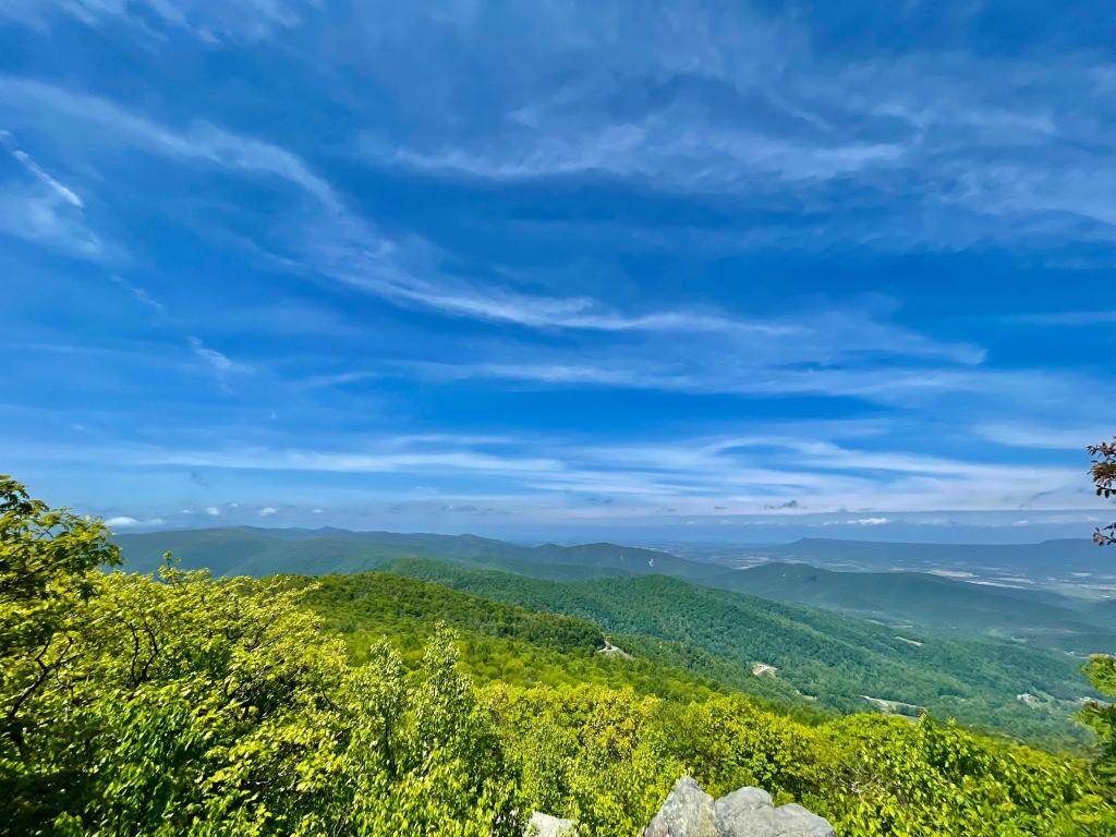 View from Hightop Summit to the hills below, cloudy and dramatic blue sky