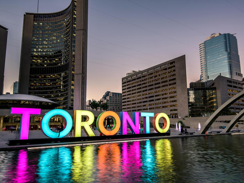Toronto, Ontario, Canada with a view of Toronto city hall and Toronto Sign in downtown at twilight.