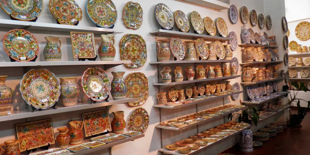 Plates and vases line the shelves inside a ceramics shop in Seville, Spain