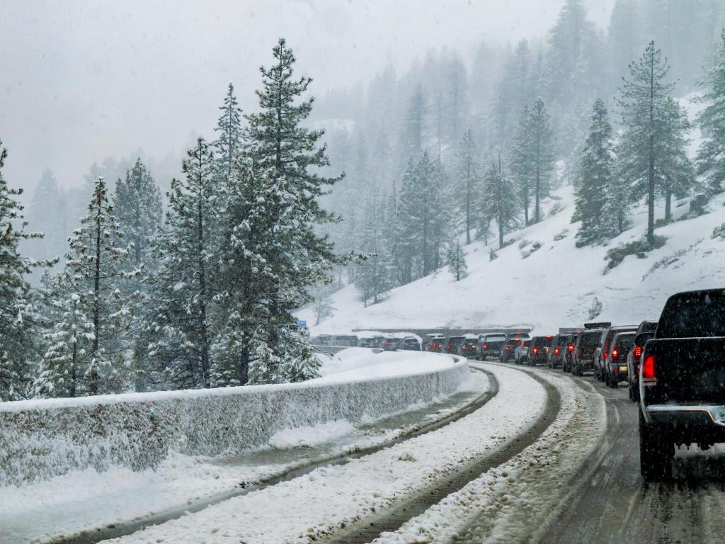 A traffic jam on I-80 as automobiles (cars) and trucks line up at a chain control checkpoint between Truckee and Sacramento in Northern California near Lake Tahoe