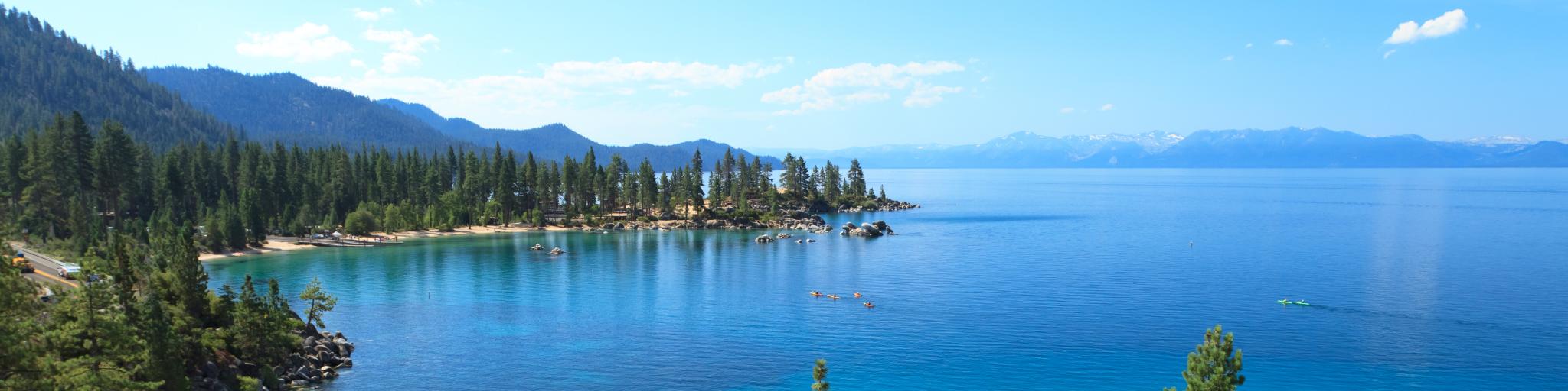 Crystal clear still waters and boulder beach of Lake Tahoe in California