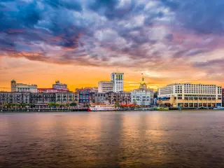Savannah, Georgia, USA skyline on the Savannah River at dusk.