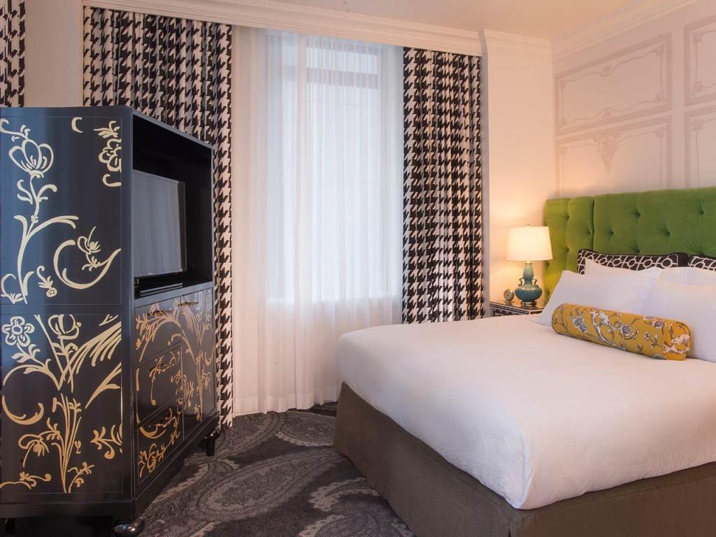 Luxury guest bedroom, with bold furniture in Queen Suite at Kimpton Hotel Monaco Pittsburgh, an IHG Hotel