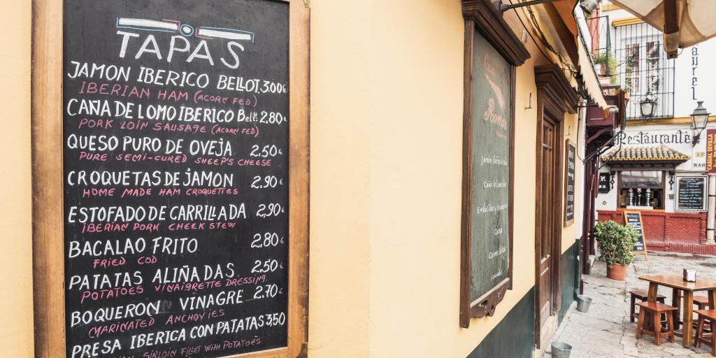 Tapas menu crawled on a blackboard in Seville, Spain