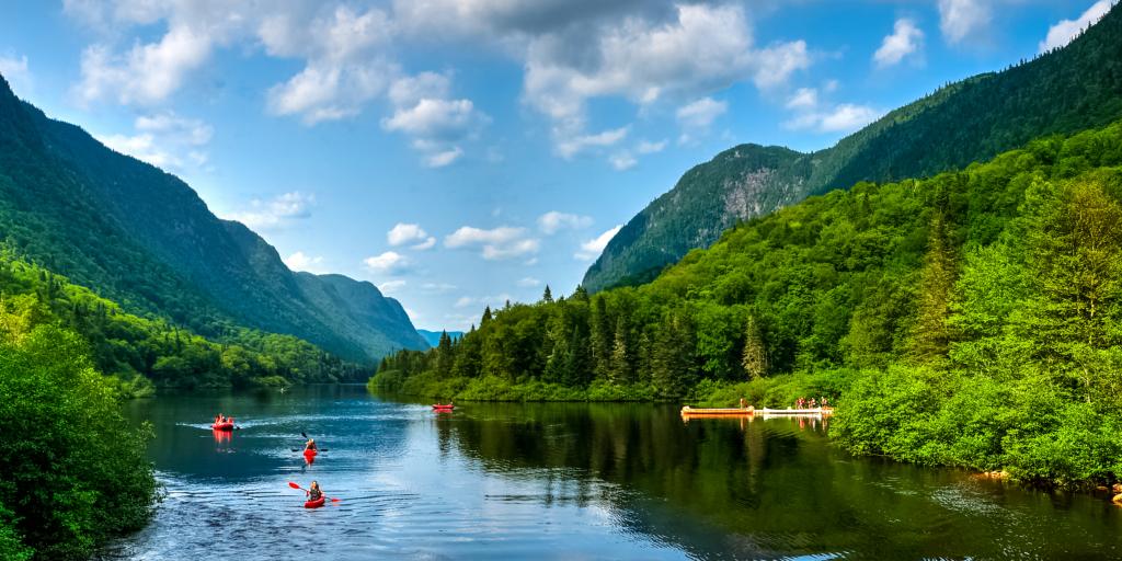 People canoeing and kayaking on a lake in Jacques-Cartier Park, Quebec