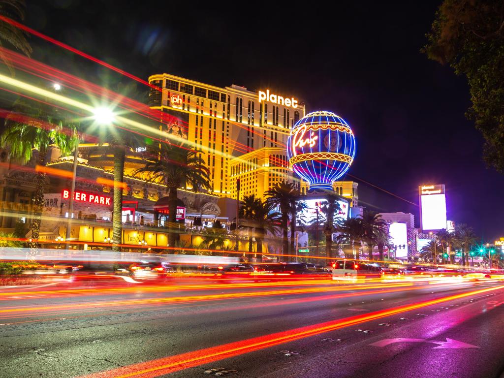 Prolonged exposure of the road with neon-lit hotels and casinos in the background at night