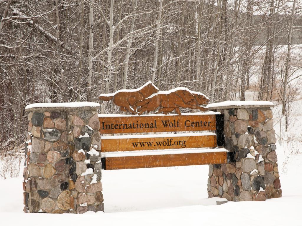 Sign in front of the International Wolf Center in Ely, Minnesota in winter with snow on the ground